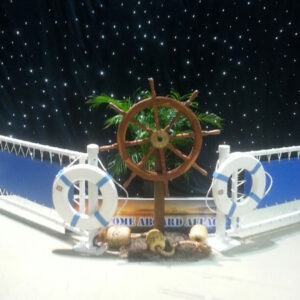 A display of a ship wheel and other items on a table.