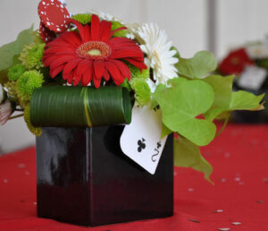 A black vase with flowers, perfect as a centerpiece for a Theme Party or Table centerpieces.