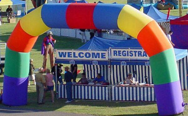 A vibrant inflatable arch adds a festive touch to an outdoor carnival event.