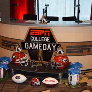 A table with footballs and helmets on it.