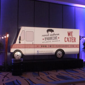 A food truck is on display in a conference room.