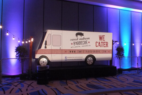 A food truck is on display in a conference room.