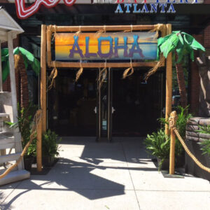 A Beach Entrance sign in front of a restaurant.