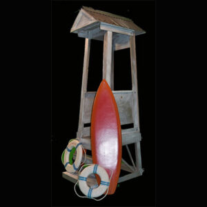 A Beach Guard Shack with a surfboard and a life preserver.