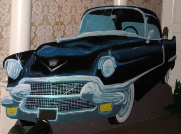 A black and white Vintage Car Flats parked in a room.