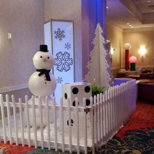 A Winter Scene in a white fence in a lobby.