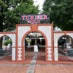 An archway with a sign that says Custom Turner Field Entrance.