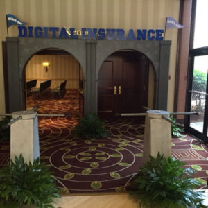 The entrance to a conference room with a sign that says Custom Entryway with Turnstiles.