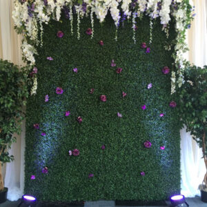 An Art Deco Backdrop with purple flowers and lights.