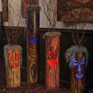 A group of Ghouli Trees with faces painted on them.