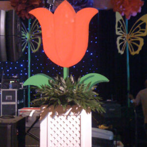 A Giant Tulip in a flower pot on a stage.