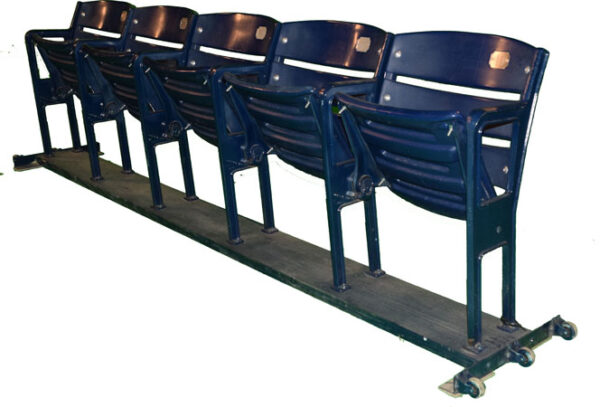 Our corporate event rentals include a convenient cart stacked with comfortable blue stadium seats that can be arranged for any type of event.