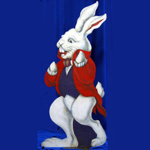 The White Rabbit in a red suit standing on a blue background.