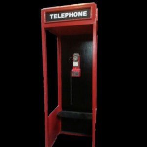 A vintage telephone booth with a black background.