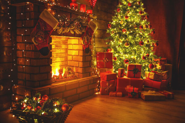 An Art Deco Backdrop and presents in front of a fireplace.