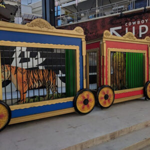 A train with a tiger and a lion on it, making it feel like an Atlanta casino party.