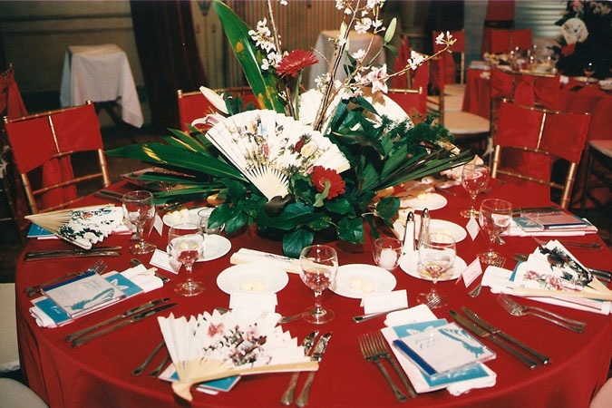 A red tablecloth on a rental table.