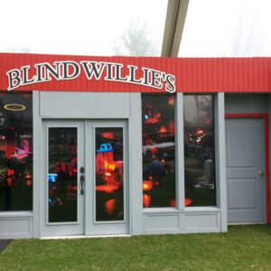 A Blind Willie's Blues Bar with a red roof and windows.