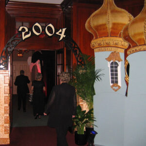 A woman is standing in front of decorated Gates.