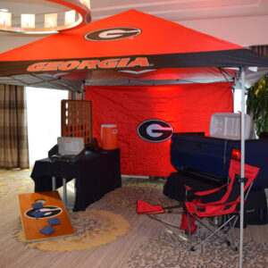 A room with a red and black Tents and Chairs.