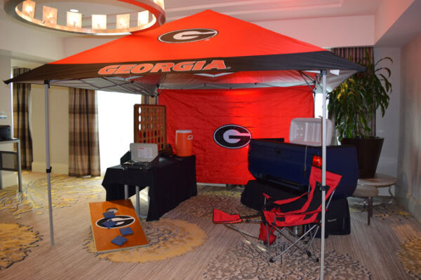 A room with a red and black Tents and Chairs.