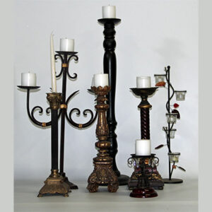 A group of candelabras with a candle in the middle.