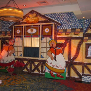 A room decorated with a Candy Store Facade for a Christmas party.