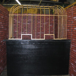 A brick wall with a bird cage in it.