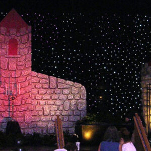 A Fire Eater with a castle in the background.