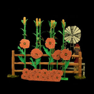 A model of a corn field with flowers and a windmill, with fences.