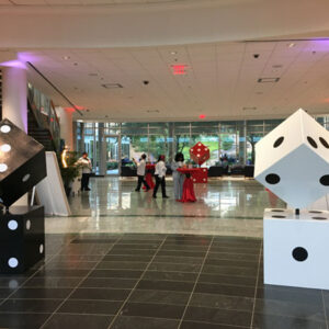 Two black and white Giant Dice in the lobby of a building.