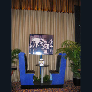 A table with two chairs and a picture on the Diner Booths.