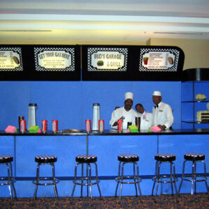 A group of people standing in front of a Diner Counter.