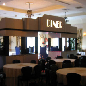 A diner entrance with tables and chairs.