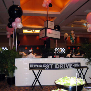 A table with Drive In Banquet balloons.