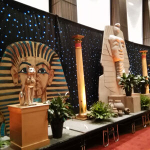 Egyptian sphinxes, pharaohs, and statues are on display at a Cargo Boxes convention.