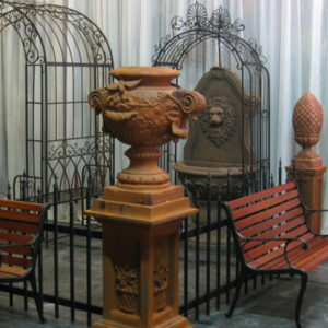 A French Garden Decor bench next to a birdcage.