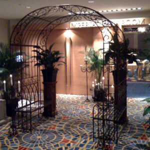 A hallway with a metal archway and French Garden Decor.