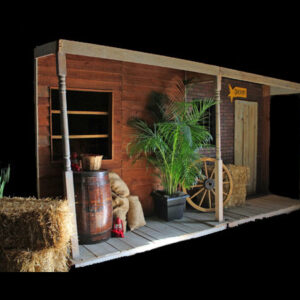 A General Store building with hay bales and a wagon.