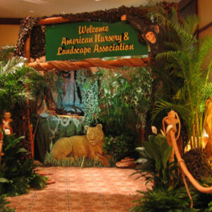 A jungle themed entrance with a lion and a giraffe.