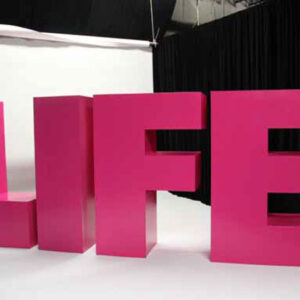 A pink sign with the word Block Letters in front of it.