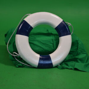 Lifebuoys sitting on a green cloth.