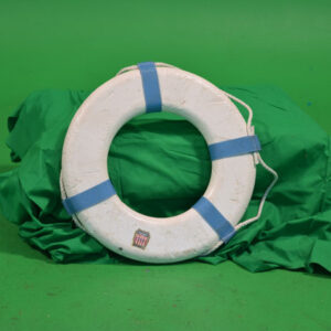 Lifebuoys on top of a green cloth.