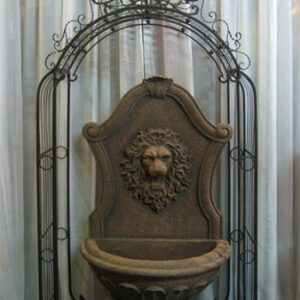 A wrought iron Fountains with a lion head.