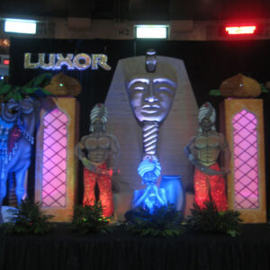 A display of Luxor Entrance statues on a stage.