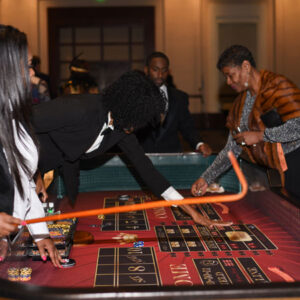 A woman playing craps tables.