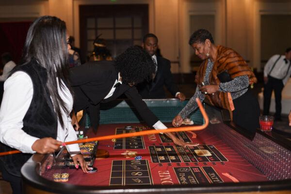 A woman playing craps tables.