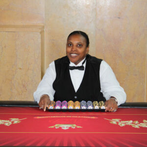 A woman sitting at a Texas Hold'em Tables.