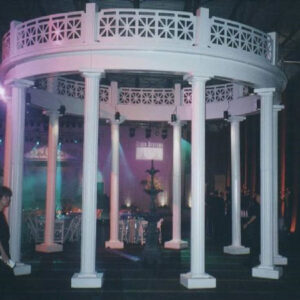 A white gazebo with columns in the middle.