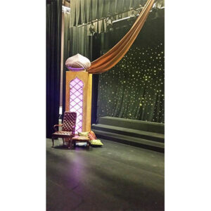 A stage set with Moroccan Columns and a curtain.